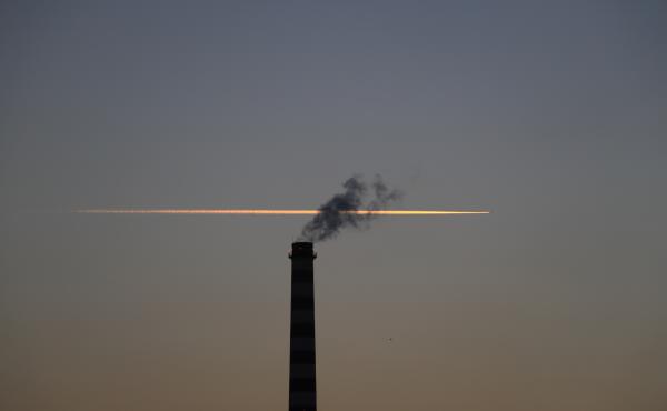 Chimney with plane trail behind