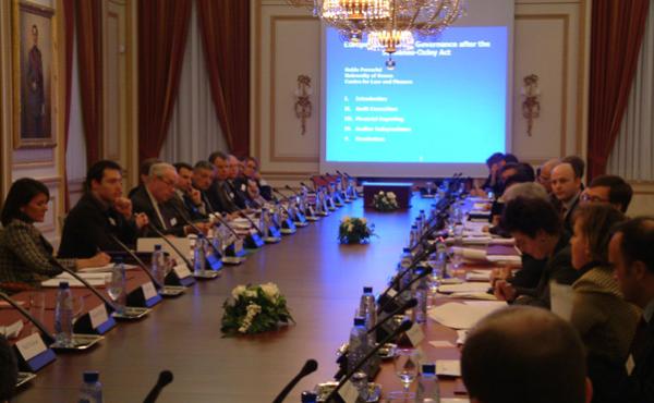 people sitting around a table for a board meeting 