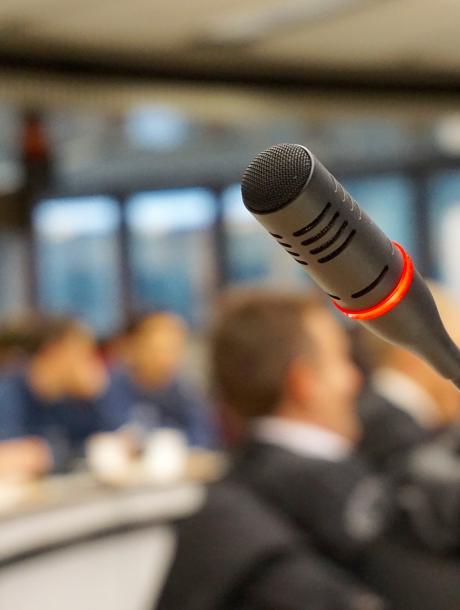 a live microphone in a blurred room of people