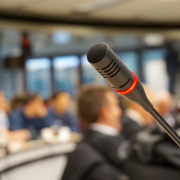 a live microphone in a blurred room of people