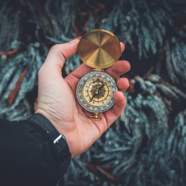 An extended arm holding a compass