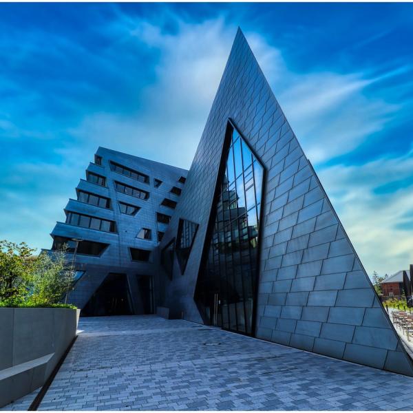 A triangular building against a blue sky