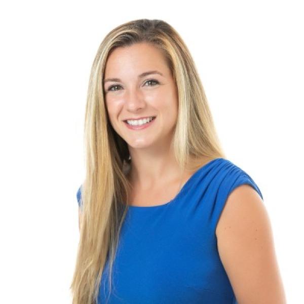 Profile picture of smiling woman in blue top